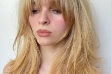 long golden blonde hair with layers and long and expended Bardot bangs is a truly Bardot-inspired hairdo