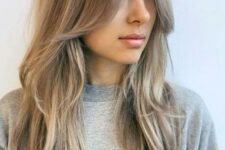 long mushroom blonde hair with a slight balayage and long layers framing the face that perfectly frame the face