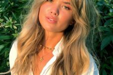 long wavy blonde hair with dimension, waves and texture and Bardot bangs looks very lovely and girlish