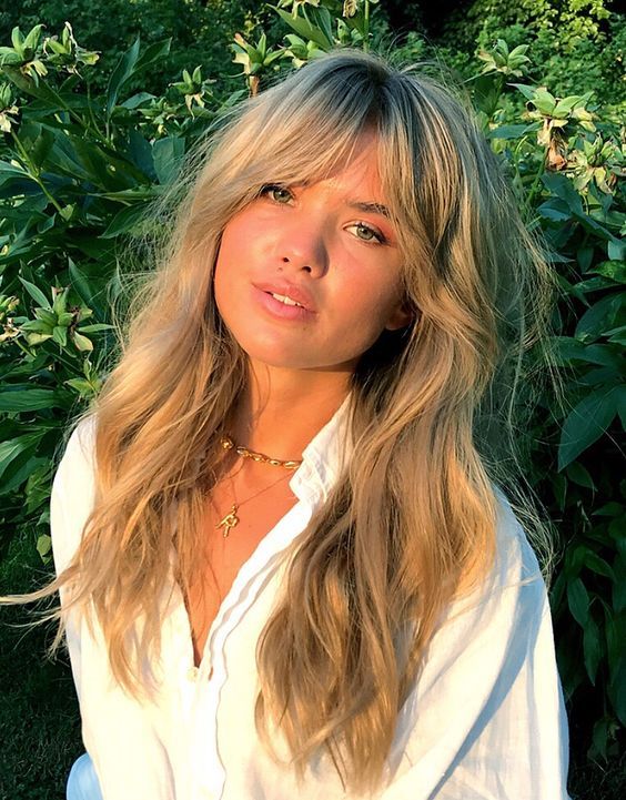 long wavy blonde hair with dimension, waves and texture and Bardot bangs looks very lovely and girlish