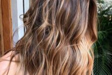 medium-length dark brunette hair with caramel balayage and a money piece plus messy beachy waves for summer