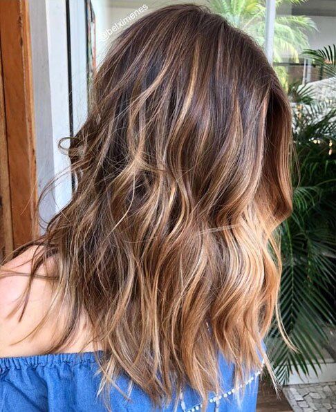 medium-length dark brunette hair with caramel balayage and a money piece plus messy beachy waves for summer