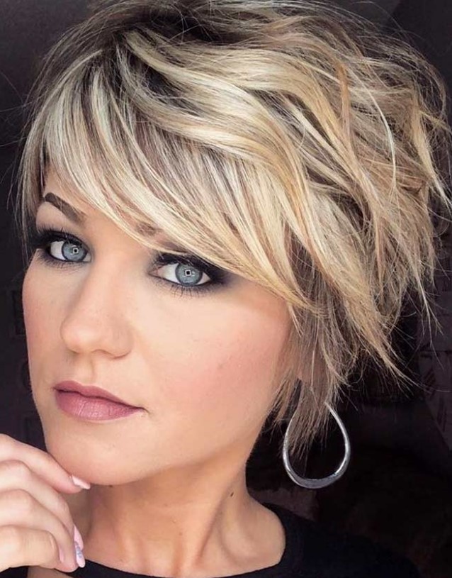 a cool blonde layered and shaggy pixie haircut with a darker root is a very stylish idea that pops up