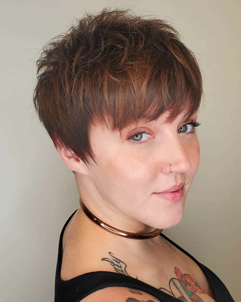 an edgy burgundy pixie haircut with layers and long bangs plus long sides is a very bold idea