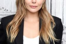 Elizabeth Olsen wearing long blonde hair with caramel balayage and long wispy bangs for a touch of cute