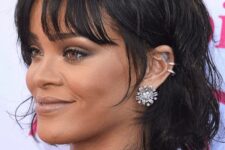 Rihanna rocking a black chin-length bob with messy waves and wispy bottleneck bangs looks jaw-dropping