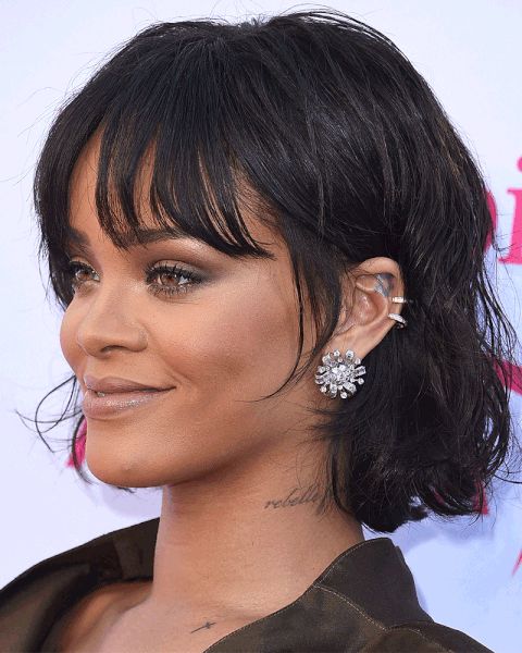 Rihanna rocking a black chin-length bob with messy waves and wispy bottleneck bangs looks jaw-dropping
