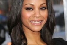 Zoe Saldana wearing a shiny black outgrown bob with side bangs and central part looks jaw-dropping