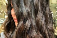 a beautiful and luxurious dark brunette medium-length wavy haircut with higihlights is a lovely idea