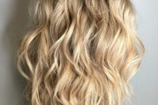 a beautiful blonde medium-length wavy haircut with messy beach waves is a perfect idea for summer