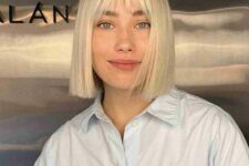 a beautiful blonde straightened bob with wispy bangs is a bold and edgy modern solution