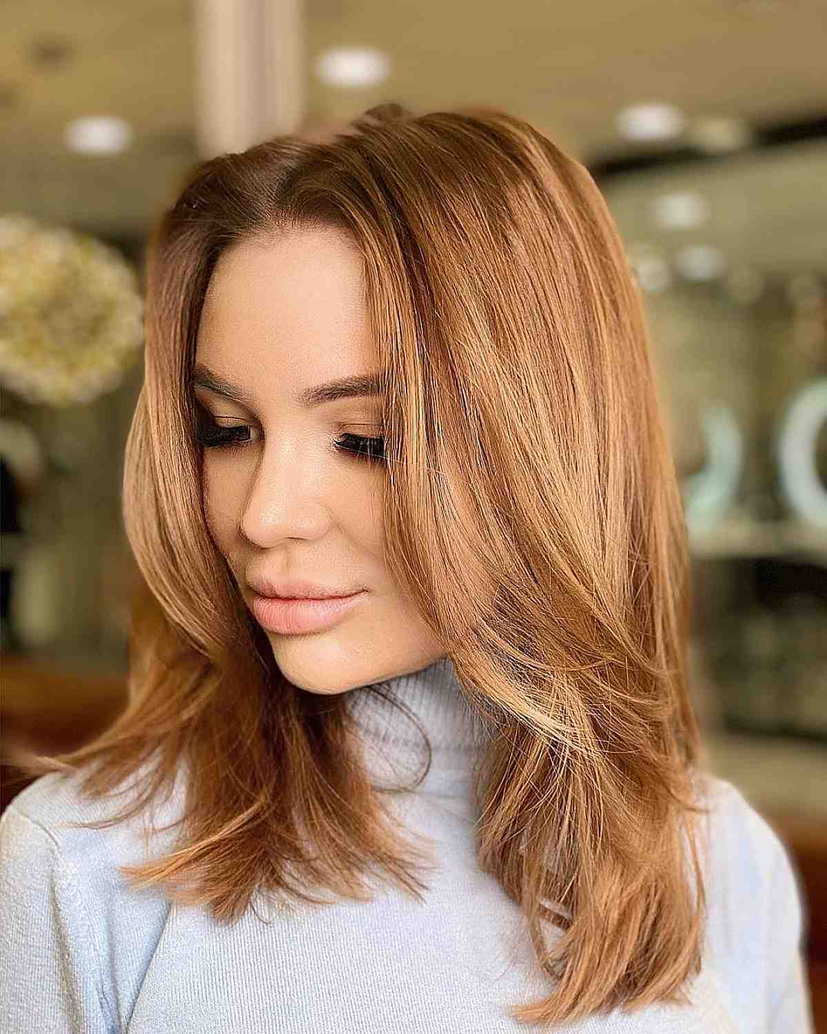 a beautiful ginger medium haircut with mid-length layers is a popular choice and lowing out your hair will give it volume