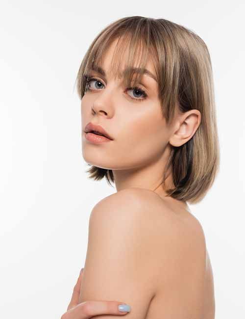 a beautiful mousy brown long bob with wispy and side bangs that beautifully frame the face
