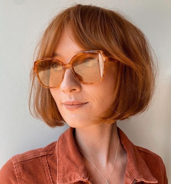 a beautiful short ginger bob with bottleneck bangs looks very lively, cute and chic and will add color to your look