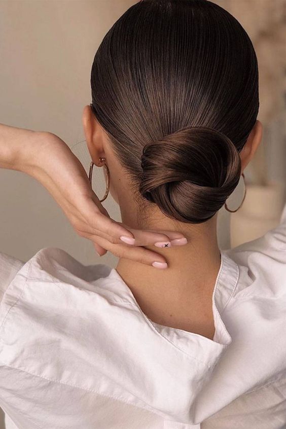 a beautiful sleek twisted low bun with a sleek top is a chic idea for many occasions and it can be worn every day, too