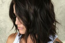 a black shaggy and choppy medium length haircut with side parting and messy waves is amazing