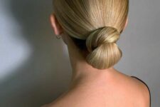 a bold and catchy sleek wrapped low bun with a sleek top is an ultra-elegant hairstyle for many occasions