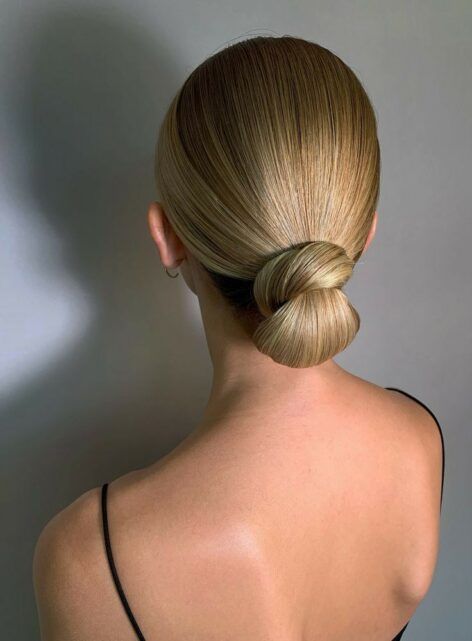 a bold and catchy sleek wrapped low bun with a sleek top is an ultra-elegant hairstyle for many occasions