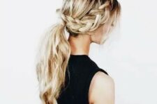 a braid going into a low ponytail with waves and locks down for a boho look