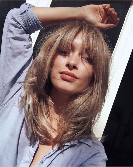 a bronde light bronde butterfly haircut with bottleneck bangs is a gorgeous idea to look 70s inspired