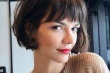 a brown French bob with bangs and waves is a classic French hairstyle that many stylish Parisian girls have tried