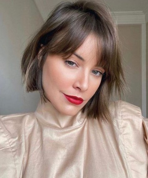 a brunette bob bob with bottleneck bangs and a bit of texture is a cool and fresh idea for trying now