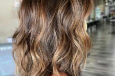 a brunette shoulder-length wavy hairstyle with caramel highlights is a very stylish and timeless idea