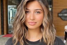 a chic brunette medium-length hairstyle with caramel balayage and waves down is amazing