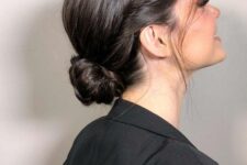 a chic low bun hairstyle with a bump, a tight twisted bun and some face-framing locks is a cool idea