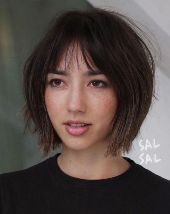 a chin-length shaggy brown bob with a slight ombre effect, wispy bangs and a bit of volume is amazing