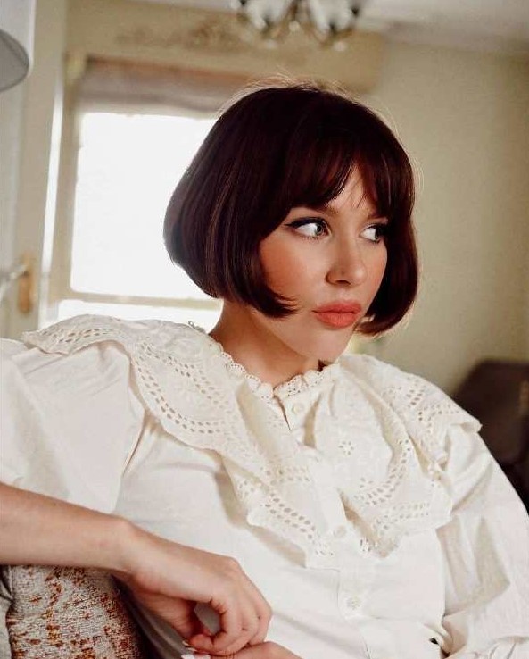 A classy dark brown jaw skimming length French bob with curtain bangs is iconic and it will turn heads