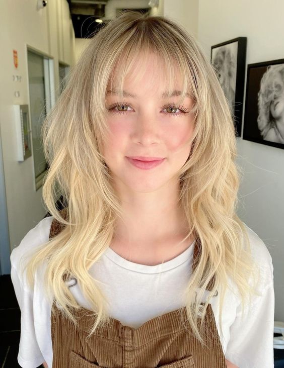 a cool octopus haircut in creamy blonde and with wispy bangs is a lovely idea to try on long hair