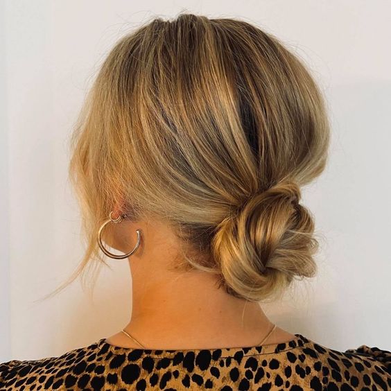 A cool twisted low bun with a bump on top and some face framing hair is always a cool idea to rock