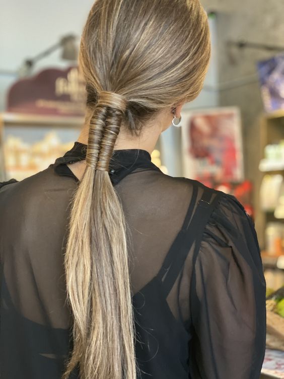 a creative modern wrapped ponytail with a sleek top is a lovely idea for a modern and edgy look
