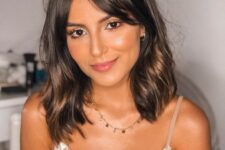 a dark brown long bob with curtain bangs and touches of softer and warmer brown is a beautiful idea, add waves for a girlish feel