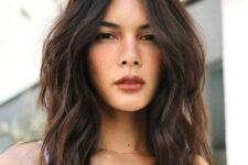 a dark brown middle-parted textured lob with caramel balayage and slight waves plus a lot of volume is a gorgeous idea