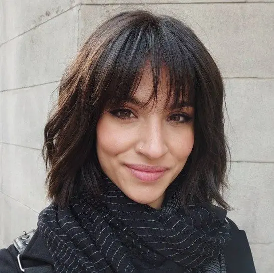 A dark brunette shaggy chin length bob with outgrown wispy bangs is a lovely idea with plenty of texture