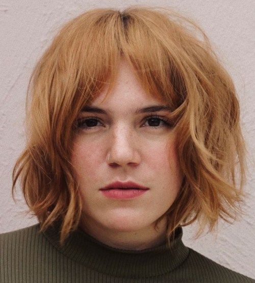 a ginger textured bob with shaggy layers and bottleneck bangs is a cathcy and cool solution