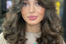 a gorgeous brunette medium butterfly haircut with side bangs and curls is a fantastic and super glam idea to try