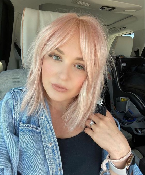 a light pink long bob with curtain bangs and textured hair is a beautiful and delicate idea