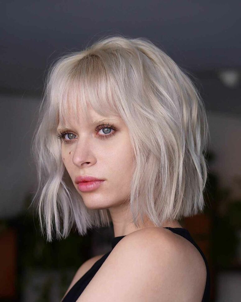 a long platinum blonde bob with waves and sipy bangs is a very eye-catching idea to rock if you want to stand out