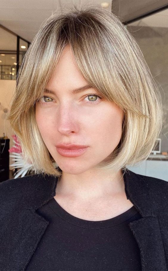 a lovely blonde bob with a darker root and soft curtain bangs is a very up-to-date idea to try
