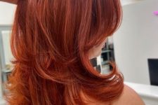 a medium butterfly haircut done in super bold red shades, with highlights and curled ends is amazing