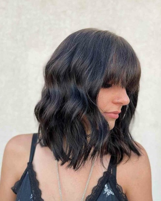 a medium haircut with bangs and waves will highlight your sexy collarbones