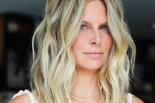 a medium layered and choppy haircut in blonde, with darker root and layers is a catchy and dimensional idea
