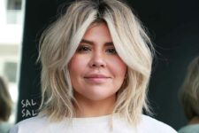 a messy blonde long bob with a darker root and textured waves plus curtain bangs is a lovely idea