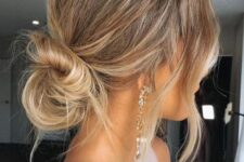 a messy low bun with a messy bump on top and waves down is a cool idea for many occasions, even weddings