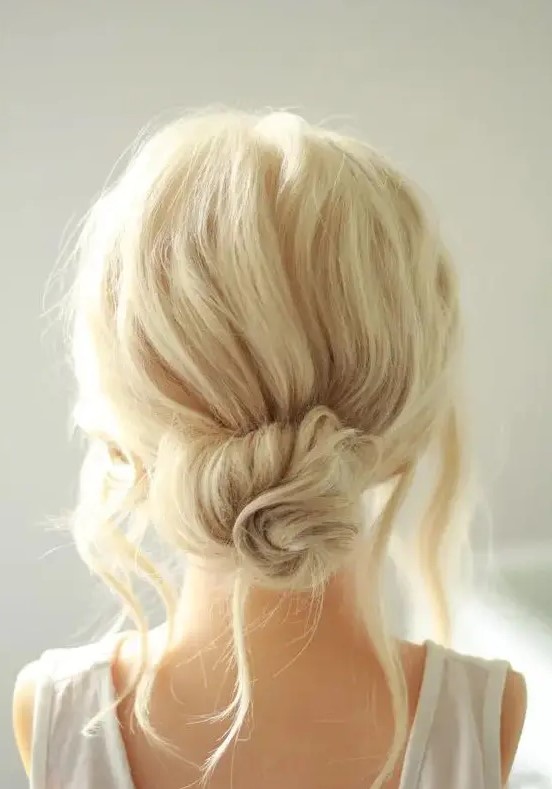 a messy twised low bun with a messy bump on top and some locks down is a chic and cool idea if your style isn't too formal