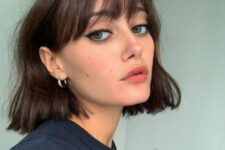 a messy wavy dark brown chin-length bob with wispy bangs is a stylish and relaxed idea, perfect for summer