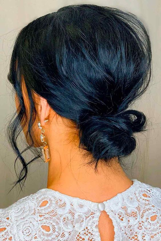 a messy wrapped low bun with a messy bump and face-framing locks is a cool idea for short or medium hair